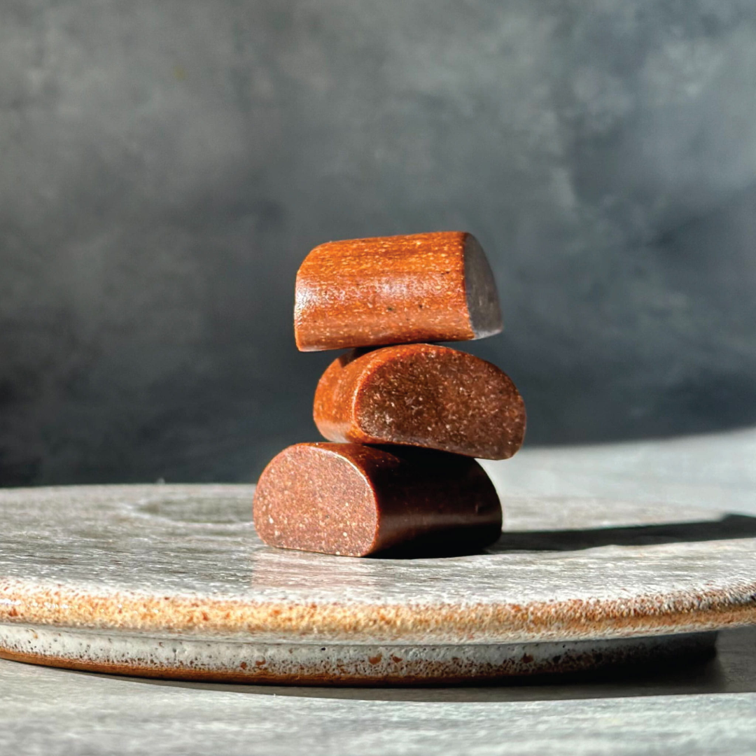 Three unwrapped Dry Brew coffee bites stacked, showing texture and size