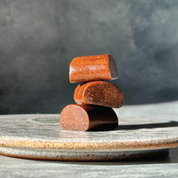 Three unwrapped Dry Brew coffee bites stacked, showing texture and size